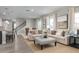 Open living space with beige sofas, ottoman, and hardwood floors at 3744 Sky Mountain Aly, Apopka, FL 32712