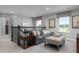 Upstairs loft area with gray sofa, ottoman, and large windows at 3744 Sky Mountain Aly, Apopka, FL 32712