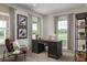 Home office with a large desk, leather chair, and natural light at 3744 Sky Mountain Aly, Apopka, FL 32712