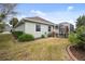 Home's backyard features a screened patio, lush landscaping, and grassy lawn at 8320 Sw 82Nd Loop, Ocala, FL 34481