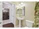 Small pedestal sink bathroom with toilet and shower access at 8320 Sw 82Nd Loop, Ocala, FL 34481