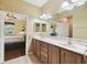 Double vanity bathroom with light wood cabinets and tile flooring at 8320 Sw 82Nd Loop, Ocala, FL 34481