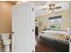 A peek into the bedroom, showing wood floors and a ceiling fan at 8320 Sw 82Nd Loop, Ocala, FL 34481