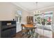 Charming dining area with a round table, elegant chandelier, and sliding glass doors, perfect for intimate gatherings and Gathering meals at 8320 Sw 82Nd Loop, Ocala, FL 34481