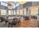 Spacious dining room with elegant lighting, large windows, and ample seating at 8320 Sw 82Nd Loop, Ocala, FL 34481