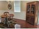 Dining room with hardwood floors, a decorative hutch, a round table, and an elegant chandelier at 8320 Sw 82Nd Loop, Ocala, FL 34481