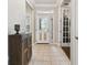 Inviting entryway with tile flooring and a charming antique cabinet at 8320 Sw 82Nd Loop, Ocala, FL 34481