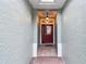Inviting entryway with a red door and tiled flooring at 8320 Sw 82Nd Loop, Ocala, FL 34481