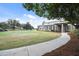Attractive building overlooking a pristine golf course with mature trees under a blue sky at 8320 Sw 82Nd Loop, Ocala, FL 34481