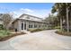 Elegant building with large windows, landscaping, and a circular driveway on a sunny day at 8320 Sw 82Nd Loop, Ocala, FL 34481