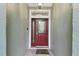 Red front door with glass panels and a welcome mat at 8320 Sw 82Nd Loop, Ocala, FL 34481