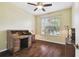 Bright home office features hardwood floors, built-in desk, and large window at 8320 Sw 82Nd Loop, Ocala, FL 34481