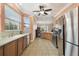 A kitchen featuring stainless steel appliances, tile flooring, and wooden cabinetry at 8320 Sw 82Nd Loop, Ocala, FL 34481