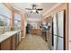 A kitchen featuring stainless steel appliances, tile flooring, and wooden cabinetry at 8320 Sw 82Nd Loop, Ocala, FL 34481