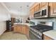 Charming kitchen with stainless steel appliances, tiled backsplash, and adjacent dining area at 8320 Sw 82Nd Loop, Ocala, FL 34481