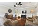 Comfortable living room featuring hardwood floors, a ceiling fan, and stylish decor, offering a relaxing and inviting space at 8320 Sw 82Nd Loop, Ocala, FL 34481