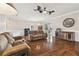This expansive living room features hardwood floors, a ceiling fan, and comfortable seating, perfect for relaxing or entertaining at 8320 Sw 82Nd Loop, Ocala, FL 34481