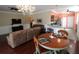 Open-concept living room boasts hardwood floors, modern lighting, and a dining nook at 8320 Sw 82Nd Loop, Ocala, FL 34481
