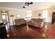 Spacious living room featuring wood floors, comfortable seating and view into kitchen area at 8320 Sw 82Nd Loop, Ocala, FL 34481