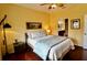 Comfortable main bedroom with hardwood floors and an en-suite bathroom at 8320 Sw 82Nd Loop, Ocala, FL 34481