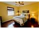 Main bedroom showcasing hardwood floors, a ceiling fan, and a cozy atmosphere at 8320 Sw 82Nd Loop, Ocala, FL 34481