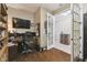 Bright office space featuring hardwood floors, an adjacent room, and built-in shelving at 8320 Sw 82Nd Loop, Ocala, FL 34481