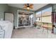A covered patio featuring a decorative ceiling fan, stone flooring and sliding glass doors leading to the outdoors at 8320 Sw 82Nd Loop, Ocala, FL 34481