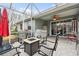 Screened patio area with ceiling fan and comfortable seating, perfect for outdoor relaxation at 8320 Sw 82Nd Loop, Ocala, FL 34481