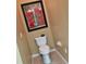 Bathroom featuring a white toilet, vintage poster art and neutral tile flooring at 8320 Sw 82Nd Loop, Ocala, FL 34481