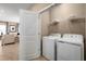 Convenient laundry room with washer, dryer, and overhead shelving at 1913 Quail Fields Cir, Winter Haven, FL 33884