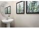 Powder room with pedestal sink and framed art at 2302 Incandescent Way, South Daytona, FL 32119