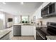 Modern kitchen with stainless steel appliances and granite countertops at 2302 Incandescent Way, South Daytona, FL 32119