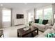 Living room with sofa, coffee table, and large windows at 2302 Incandescent Way, South Daytona, FL 32119