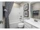 Clean bathroom with shower and tub, stylish black and white shower curtain and modern fixtures at 424 Hammock Oaks Blvd, Lady Lake, FL 32159