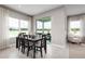 Well-lit dining area with large windows, sliding door, and a contemporary table set for six at 424 Hammock Oaks Blvd, Lady Lake, FL 32159