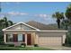 Charming single-Gathering home features a two-car garage, and well-manicured landscaping at 424 Hammock Oaks Blvd, Lady Lake, FL 32159