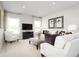 Inviting living room filled with natural light, featuring modern decor and comfortable white seating at 424 Hammock Oaks Blvd, Lady Lake, FL 32159