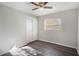 Cozy bedroom with vinyl flooring and a ceiling fan, featuring closet storage at 1360 10Th Ne Ct, Winter Haven, FL 33881