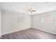 Light-filled bedroom with gray vinyl flooring and large windows at 1360 10Th Ne Ct, Winter Haven, FL 33881