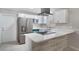 Modern kitchen with stainless steel appliances, white cabinetry, and stone countertops and backsplash at 1360 10Th Ne Ct, Winter Haven, FL 33881