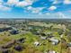 Aerial view with ponds and trees under a beautiful partly cloudy blue sky at 5030 Alderman Rd, Lakeland, FL 33810