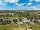 Expansive aerial view of the property, showcasing the surrounding landscape and neighborhood with mature trees at 5030 Alderman Rd, Lakeland, FL 33810