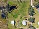 Property aerial showcasing pond, mature trees and grassy areas at 5030 Alderman Rd, Lakeland, FL 33810