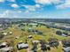 Aerial view of houses and ponds in the neighborhood with a beautiful blue sky and clouds at 5030 Alderman Rd, Lakeland, FL 33810