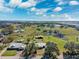 Aerial view of neighborhood with ponds and green landscape under a partly cloudy sky at 5030 Alderman Rd, Lakeland, FL 33810