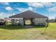 Rustic barn with a metal roof and a charming exterior, surrounded by green grass and a sunny sky at 5030 Alderman Rd, Lakeland, FL 33810