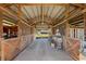 The barn interior has exposed beams and ample space, ideal for various agricultural or storage needs at 5030 Alderman Rd, Lakeland, FL 33810