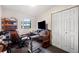 Functional bedroom featuring a desk, TV, and built-in shelving for storage at 5030 Alderman Rd, Lakeland, FL 33810