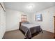 Clean bedroom with a comfortable bed, two windows, and neutral-colored carpet at 5030 Alderman Rd, Lakeland, FL 33810