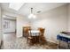 Well-lit dining room features a round table, four chairs, and a vintage chandelier at 5030 Alderman Rd, Lakeland, FL 33810